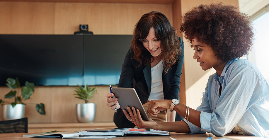 two professional women looking at laptop