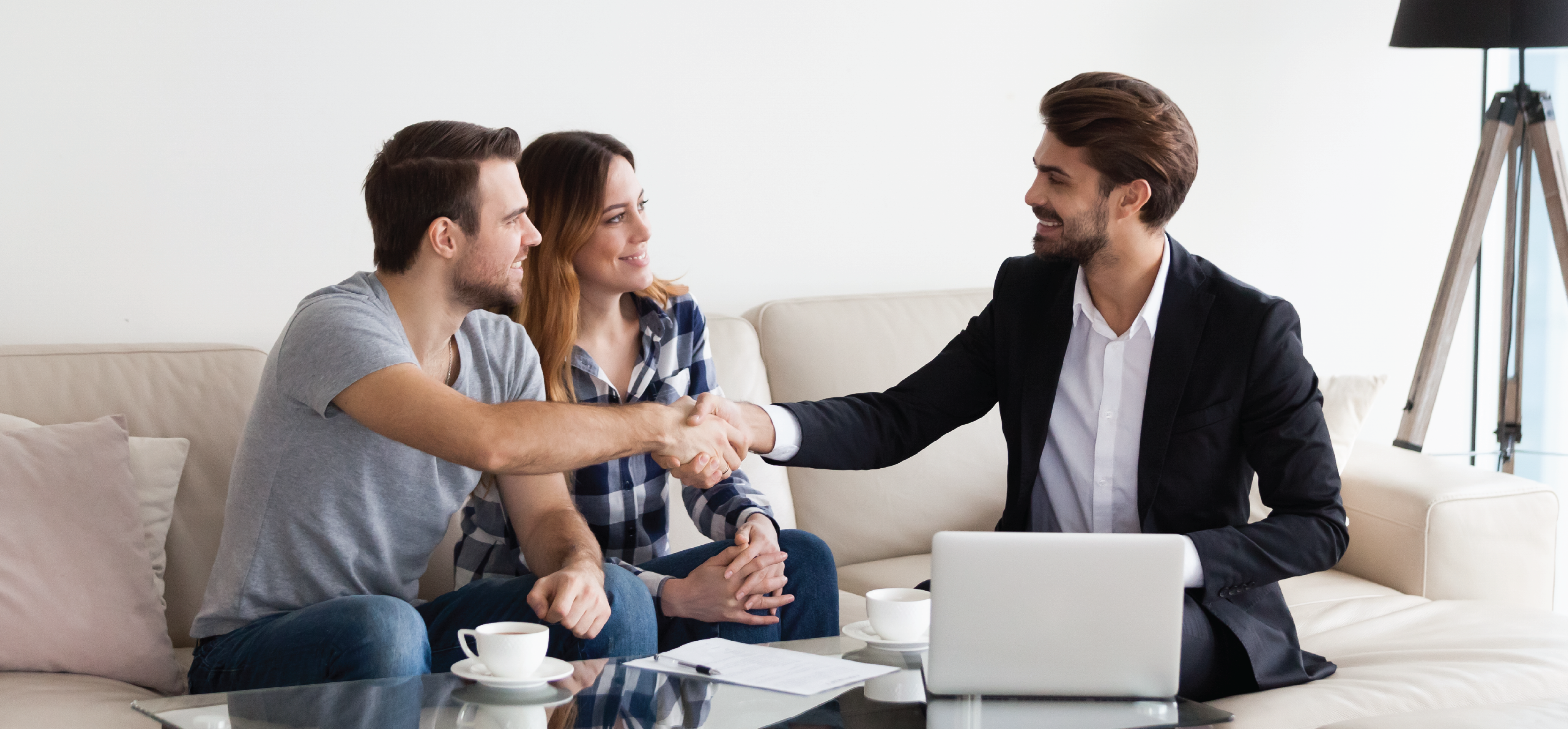 An agent in a lounge room selling Plezzel's digital marketing to vendors ready to sell their home.