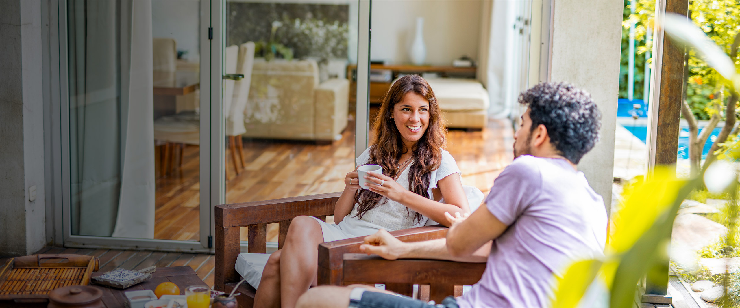 Couple sitting outside having breakfast in yard